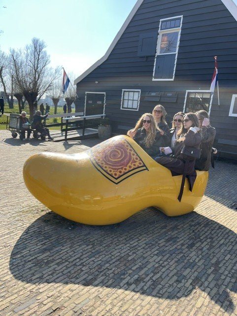 Guests sitting in a giant wooden clog