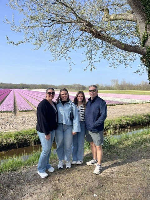 Guests standing beside colourful tulip fields in the Dutch bulb region